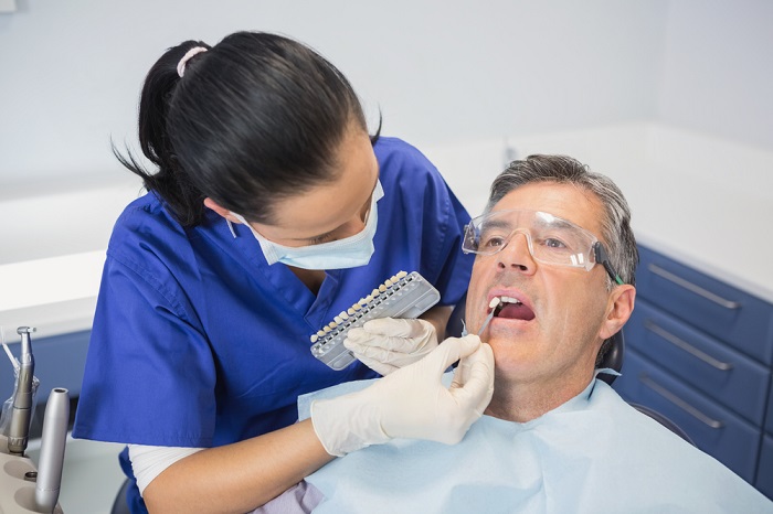 a dentist treating her patient