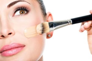 applying foundation with a brush