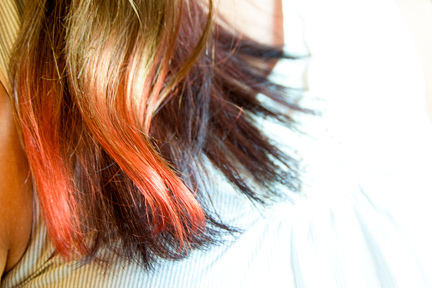 a woman's hair with red tips