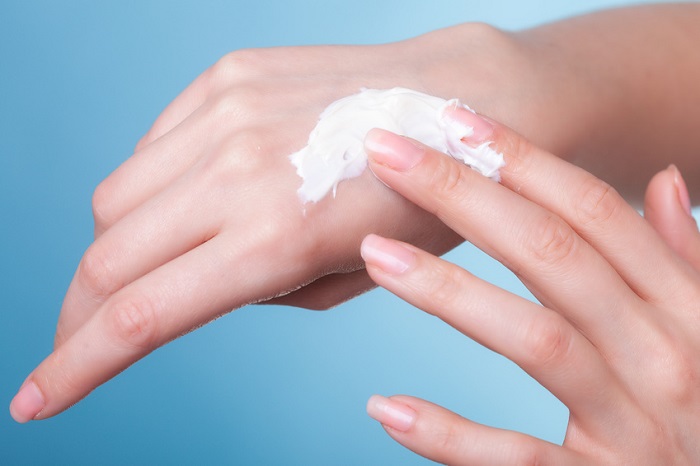 female hands moisturized with hand cream