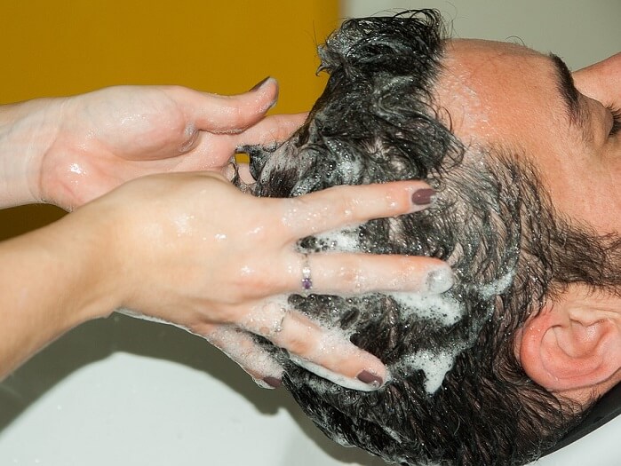 a man being shampooed by a beautician