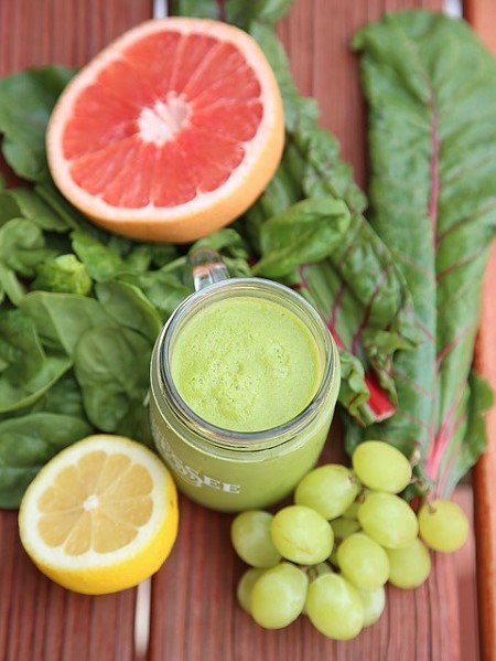 a green smoothie jar and citrics