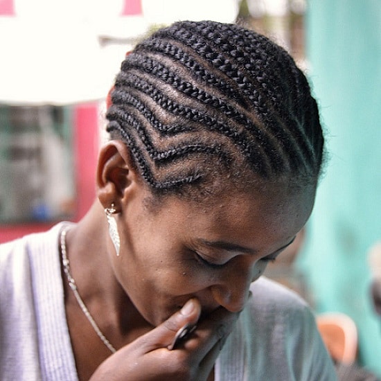 an afro-american woman with cornrows hairstyle