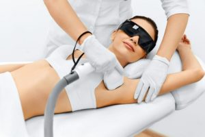 a woman doing a laser hair removal procedure