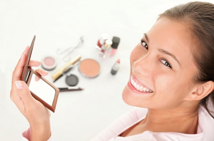 a woman applying makeup