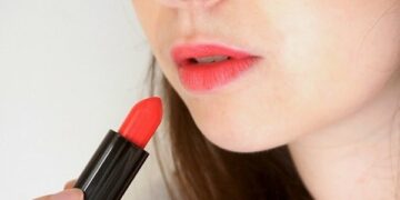 Applying lipstick