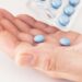 1 hand holding pills