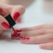 1 woman painting her nails 1