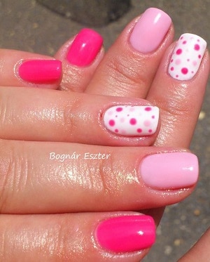 Manicure with two shades of pink nail polish and white nail polish