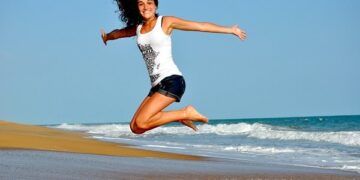 beautiful girl jumping on beach