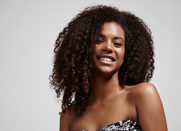 woman with curly hair smiling