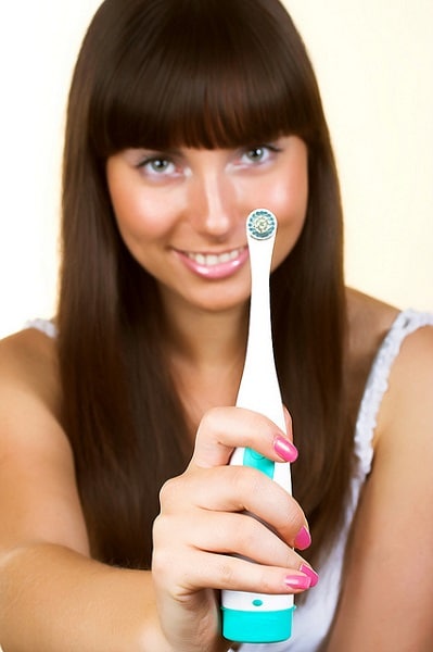 Woman showing a toothbrush
