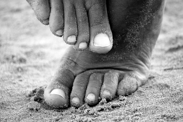 woman's feet in the sand