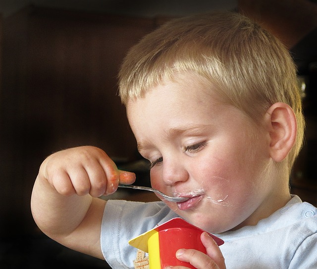 child eating yogurt