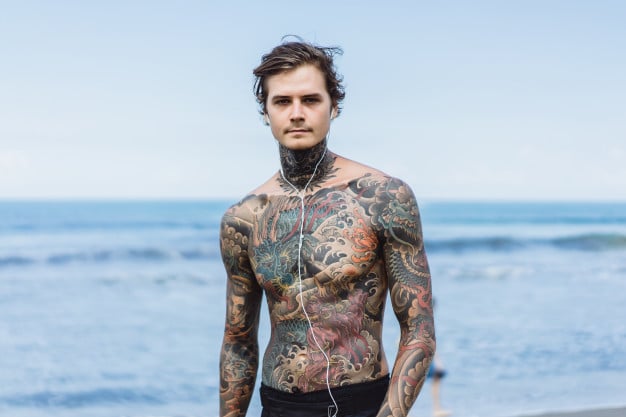 tattooed man with headphones